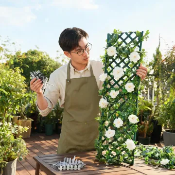 Outdoor greenery specialist reviewing trellis panel